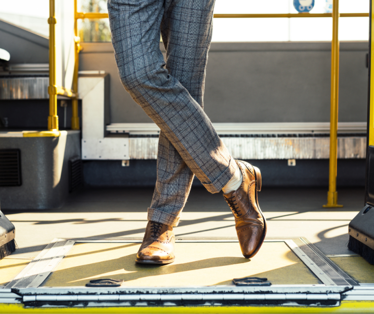 man in dress clothes on a bus